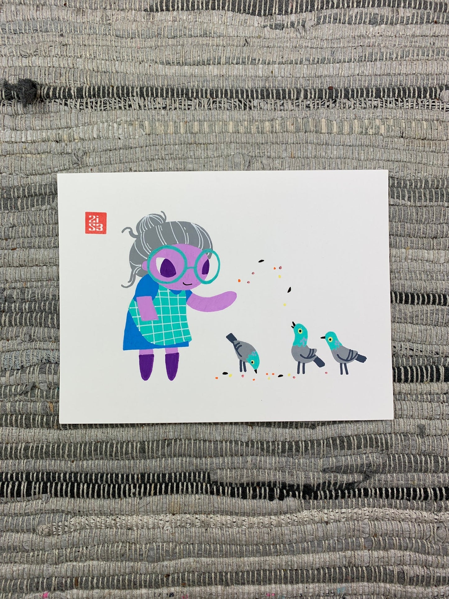 Original artwork of an older grandmother type character feeding three pigeons.