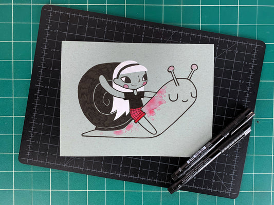 Studio shot of an original illustration of a girl waving while riding a smiling snail. Made using ink, watercolor, and gouache.