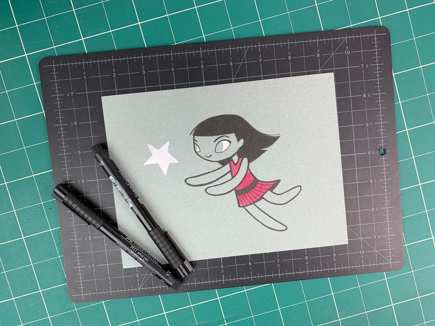 Studio shot of an original illustration of a girl in a red dress chasing a white star. Made using ink, watercolor, and gouache.