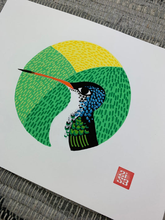 Original artwork of a hummingbird with a textured background framed in a circle.