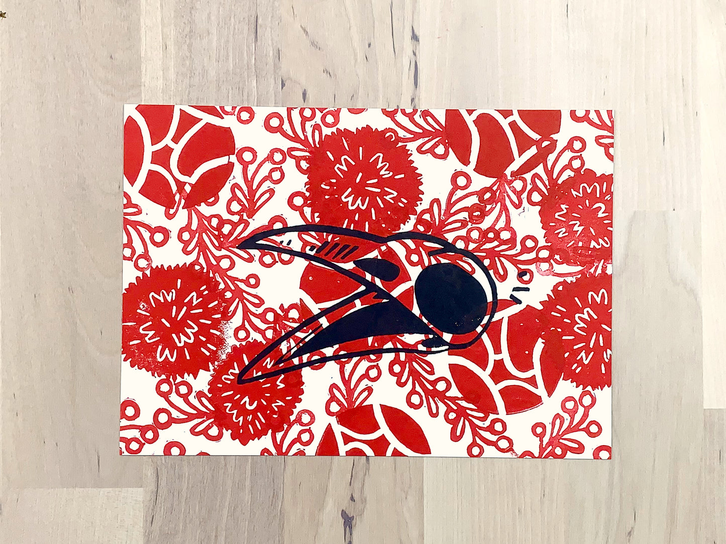 Original art print by Amber Orenstein. Block printed crow skull over red floral background pattern.