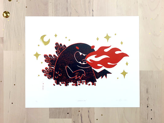 Original limited edition #2 art print by Amber Orenstein. Two color, red and black, reduction block print of a Japanese kaiju monster roaring with flames while destroying a city with gold stars and moon.