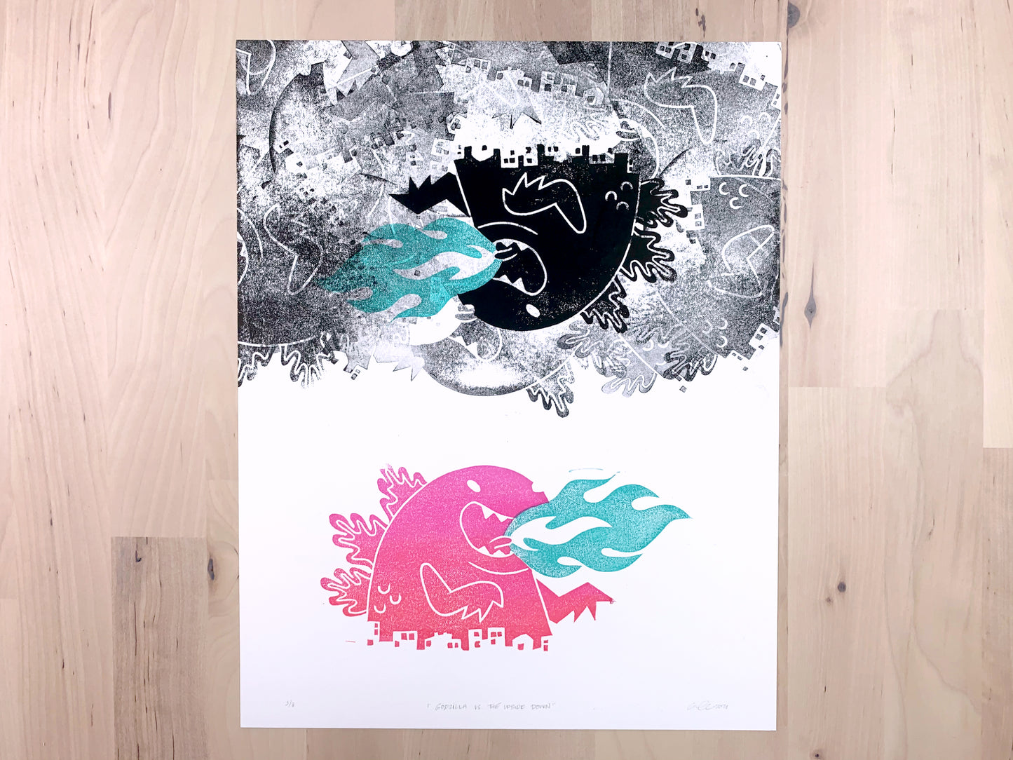 Original art print by Amber Orenstein. Block printed pink and turquoise Japanese kaiju monster underneath a cloud of randomly placed black prints of the same monster.