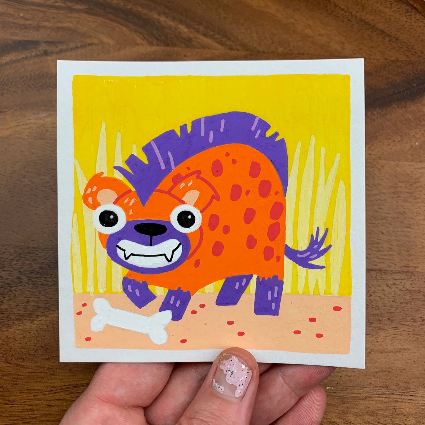 Original artwork of a cute hyena with a big smile and a bone. Materials used: Uni-Posca paint markers.