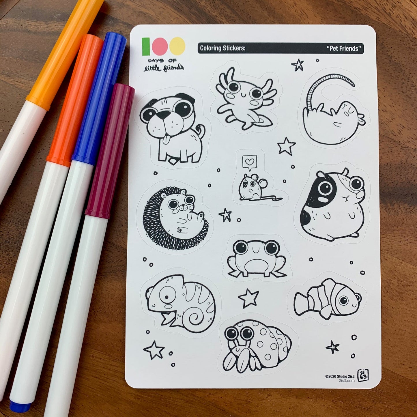 Markers and a sticker sheet with 10 little animal stickers on it. A Pug, Salamander, Rat, Mouse, Hedgehog, Guinea Pig, Frog, Chameleon, Hermit Crab, and Clown Fish.