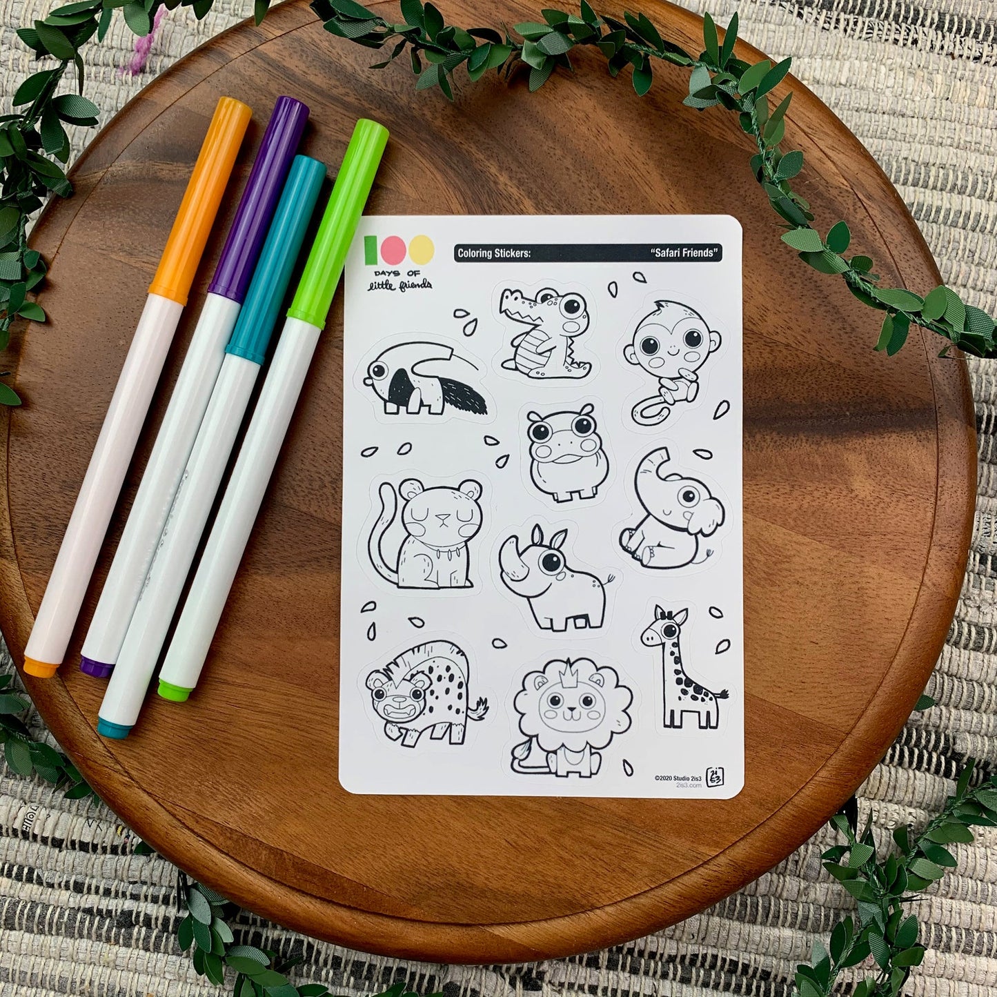 Markers and a sticker sheet with 10 little animal stickers on it. A Anteater, Alligator, Monkey, Hippo, Panther, Rhino, Elephant, Hyena, Lion, and Giraffe.