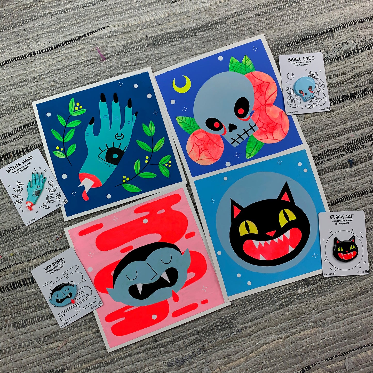 Set of four paintings with matching clay pins.