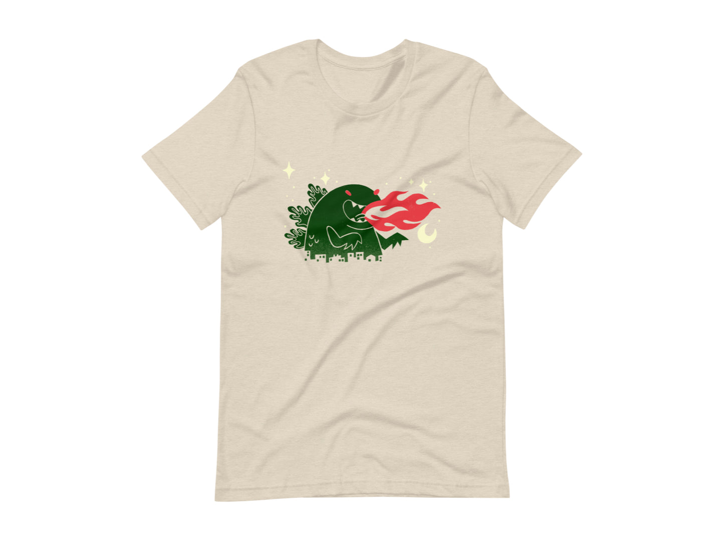 T-shirt with block print style art by Amber Orenstein. Beige shirt with a green godzilla, yellow stars, and red flames coming from his mouth.