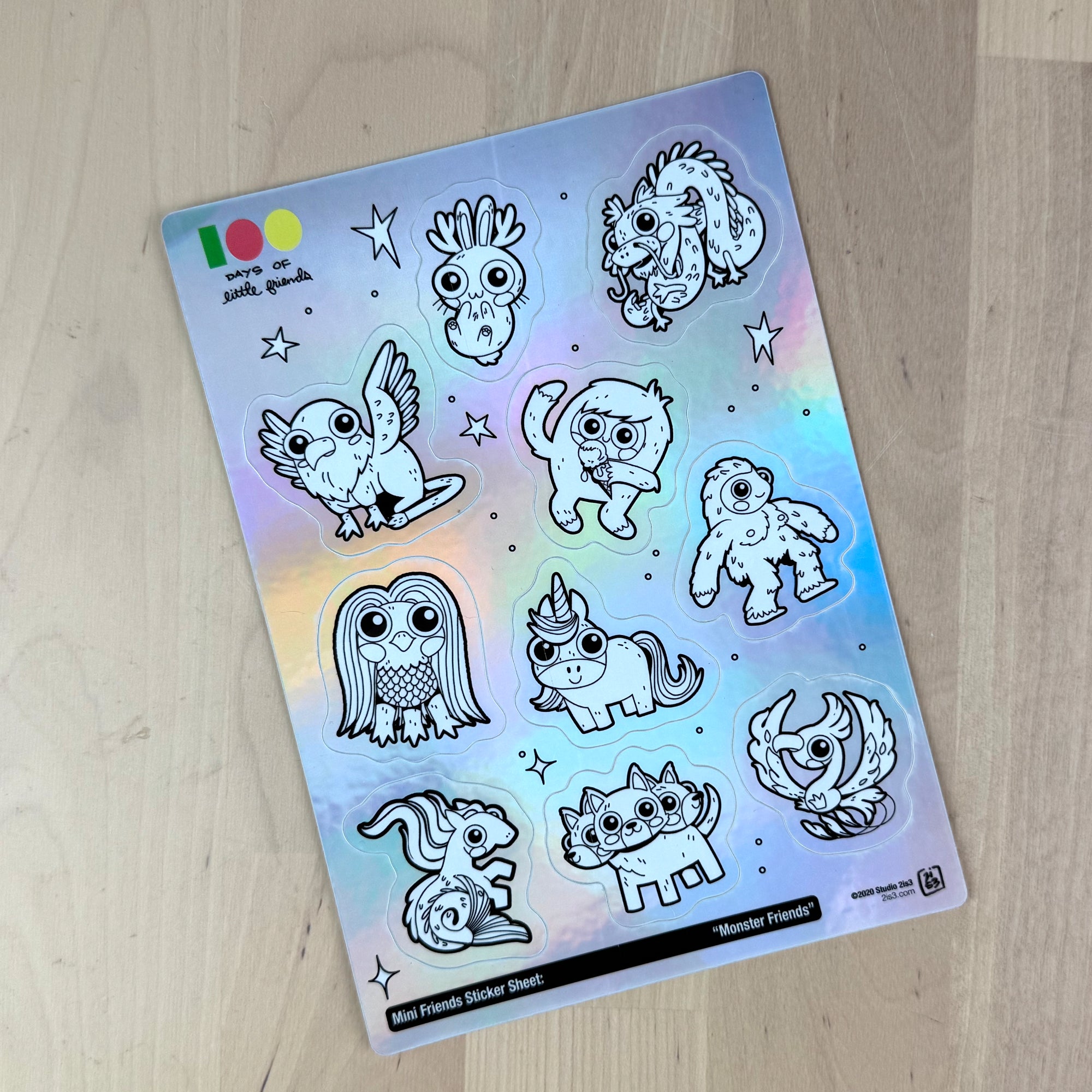 Holographic sticker sheet with cute little monsters you can color