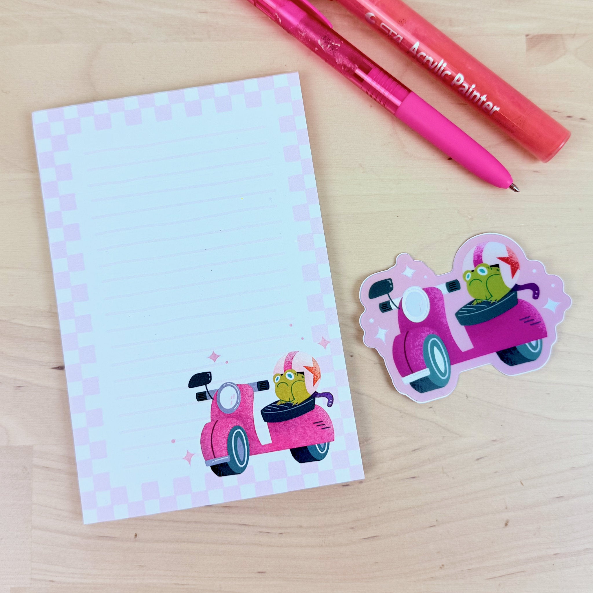 Jump Start! notepad with matching vaporwave holographic sticker of a grumpy frog on a scooter.
