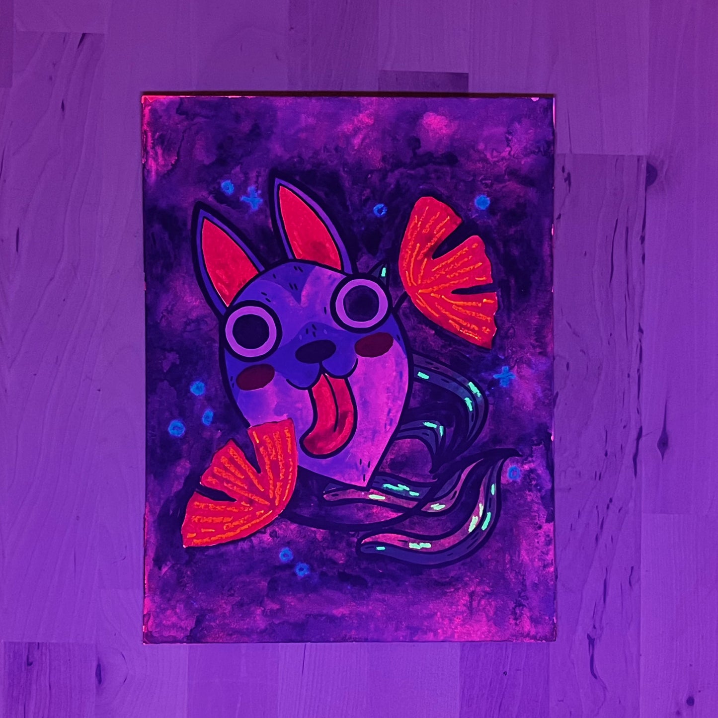 Photo of artwork in blacklight