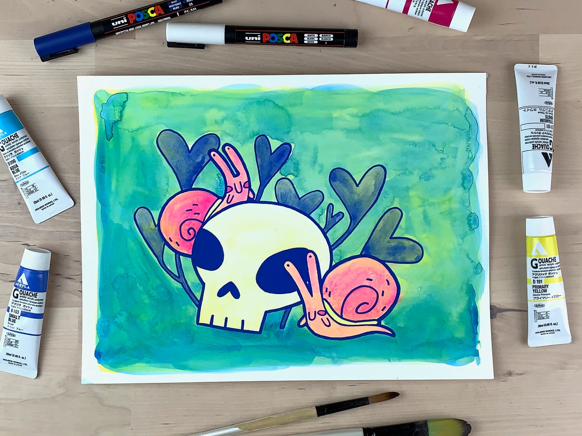 Painting of two snails crawling around a skull with some clovers in the background.