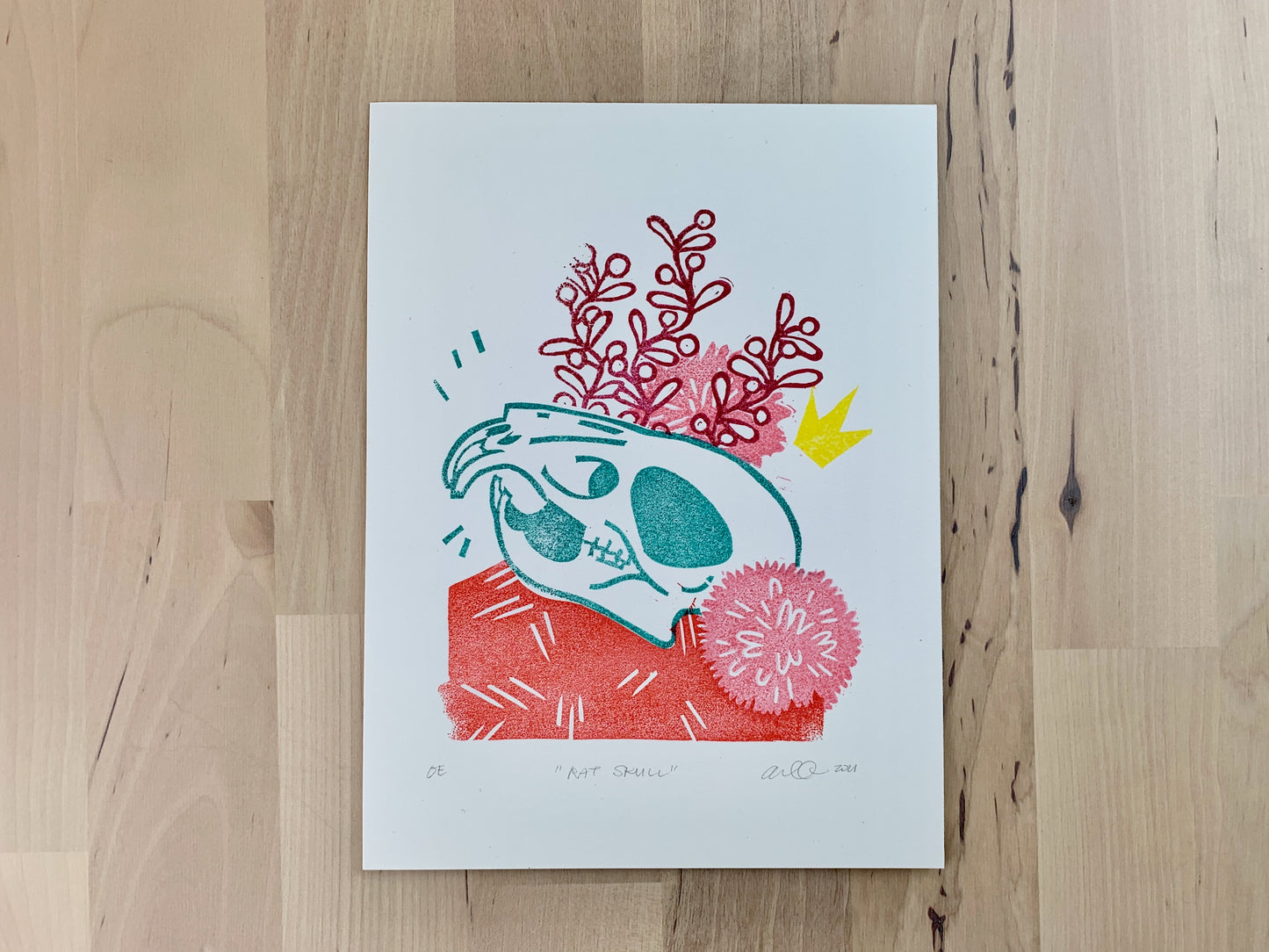 Original art print by Amber Orenstein. A relief print of a lion skull with crown and floral accents.