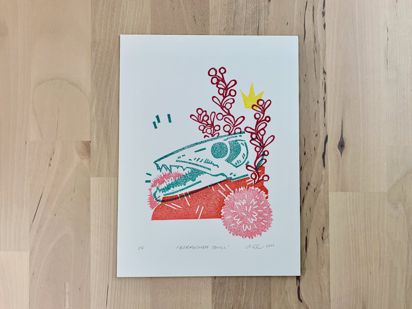 Original art print by Amber Orenstein. A relief print of a barracuda skull with crown and floral accents.