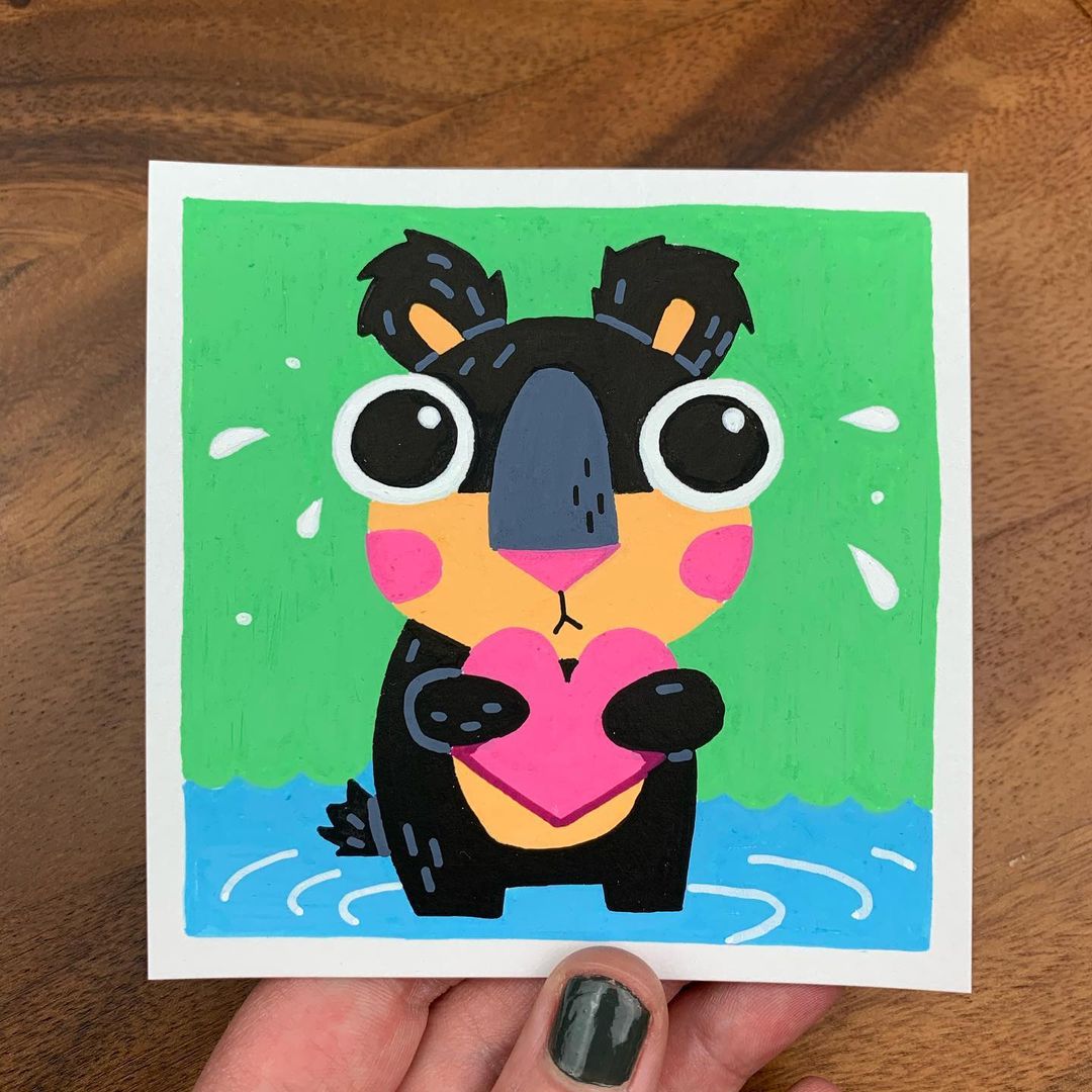 Original artwork of a cute black bear crying while hugging a heart. Materials used: Uni-Posca paint markers.