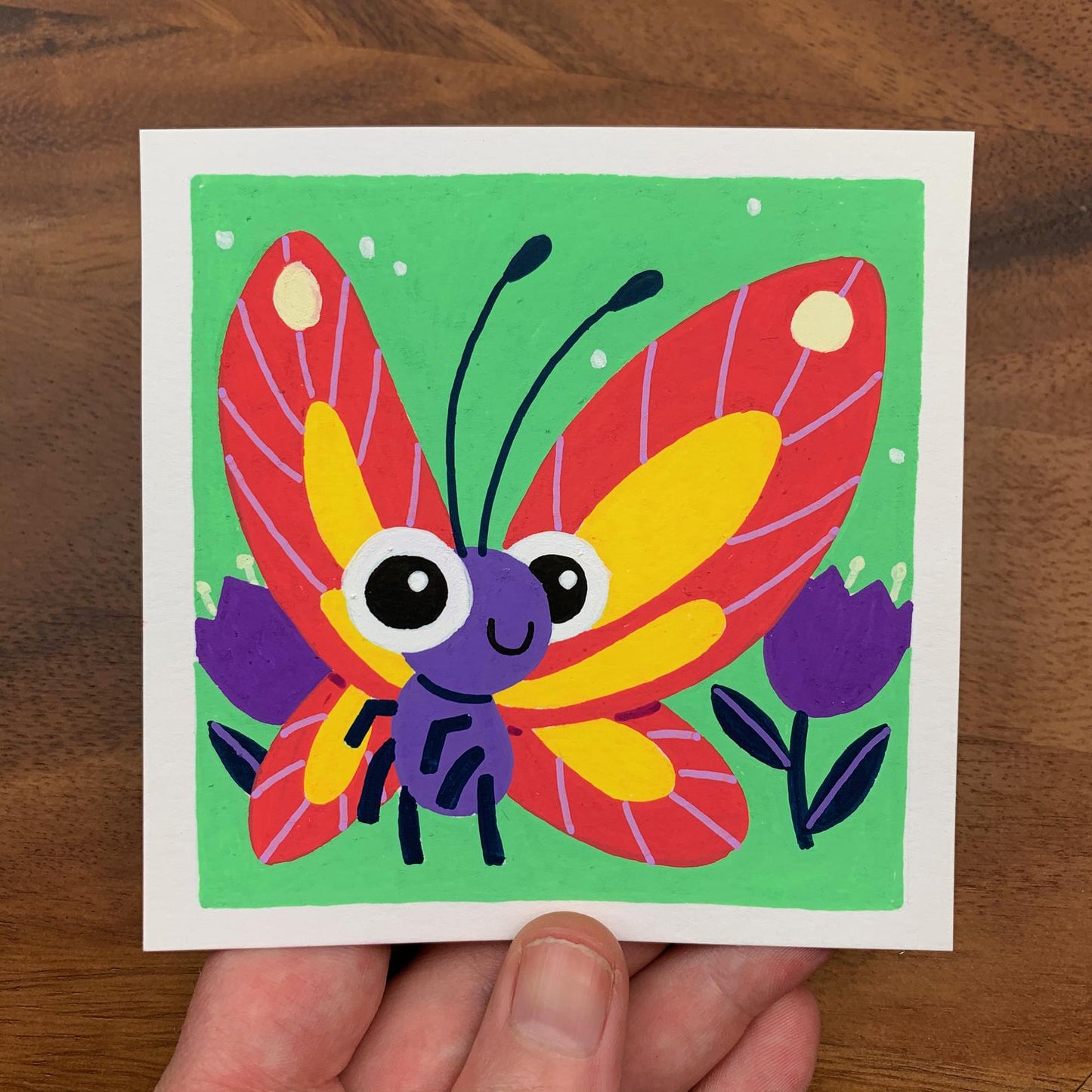 Original artwork of a cute butterfly in a tulip field. Materials used: Uni-Posca paint markers.