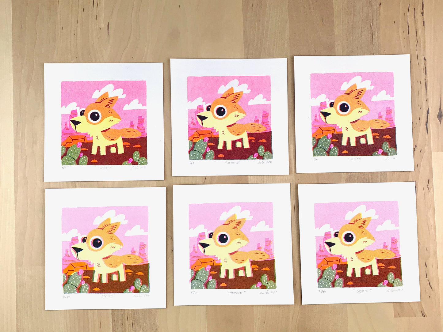 Six Risograph prints of a cute coyote illustration in a pink desert scene showing the unique variations.