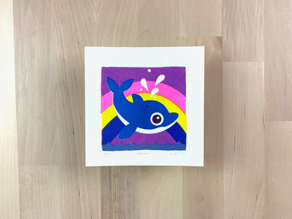 Risograph print of an illustration of a cute dolphin jumping out of the water with a rainbow behind it.