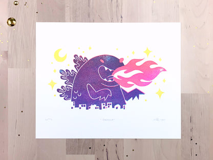 Original limited edition #2 art print by Amber Orenstein. Two color, pink and turquoise, reduction block print of a Japanese kaiju monster roaring with flames while destroying a city with yellow stars and moon.