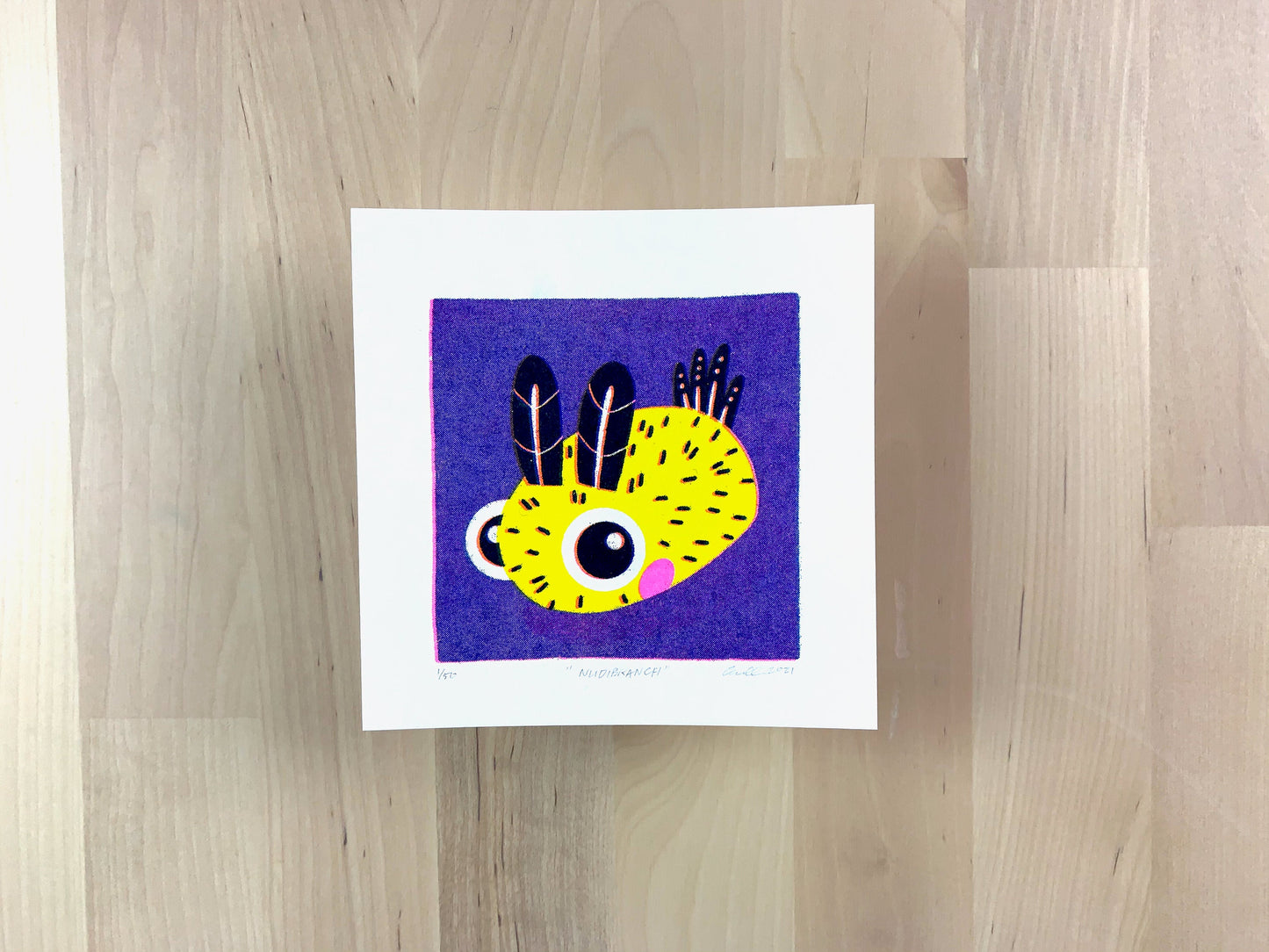 Risograph print of a cute nudibranch, sea bunny, illustration on a purple background.