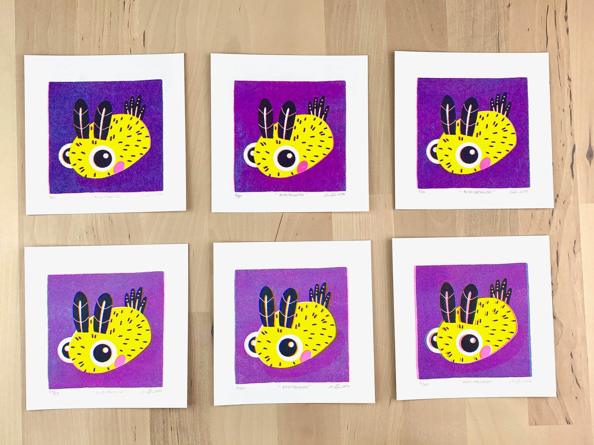 Six Risograph prints of a cute Risograph print of a cute nudibranch, sea bunny, illustration on a purple background showing the unique variations.