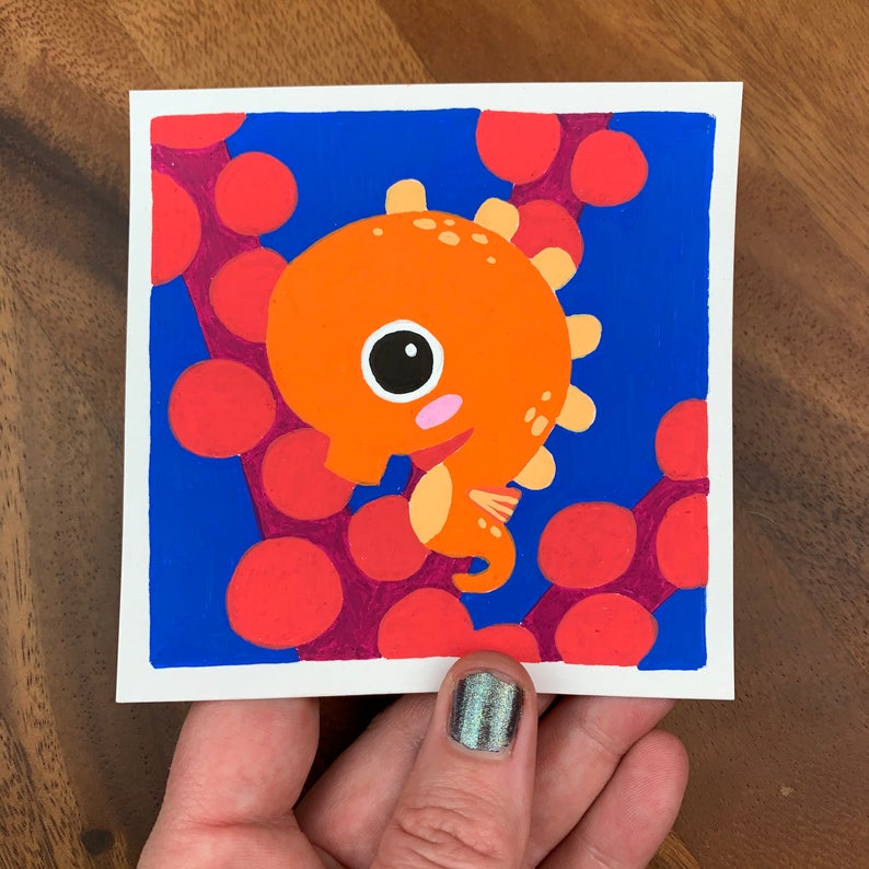 Original artwork of a cute orange seahorse in front of some red coral. Materials used: Uni-Posca paint markers.
