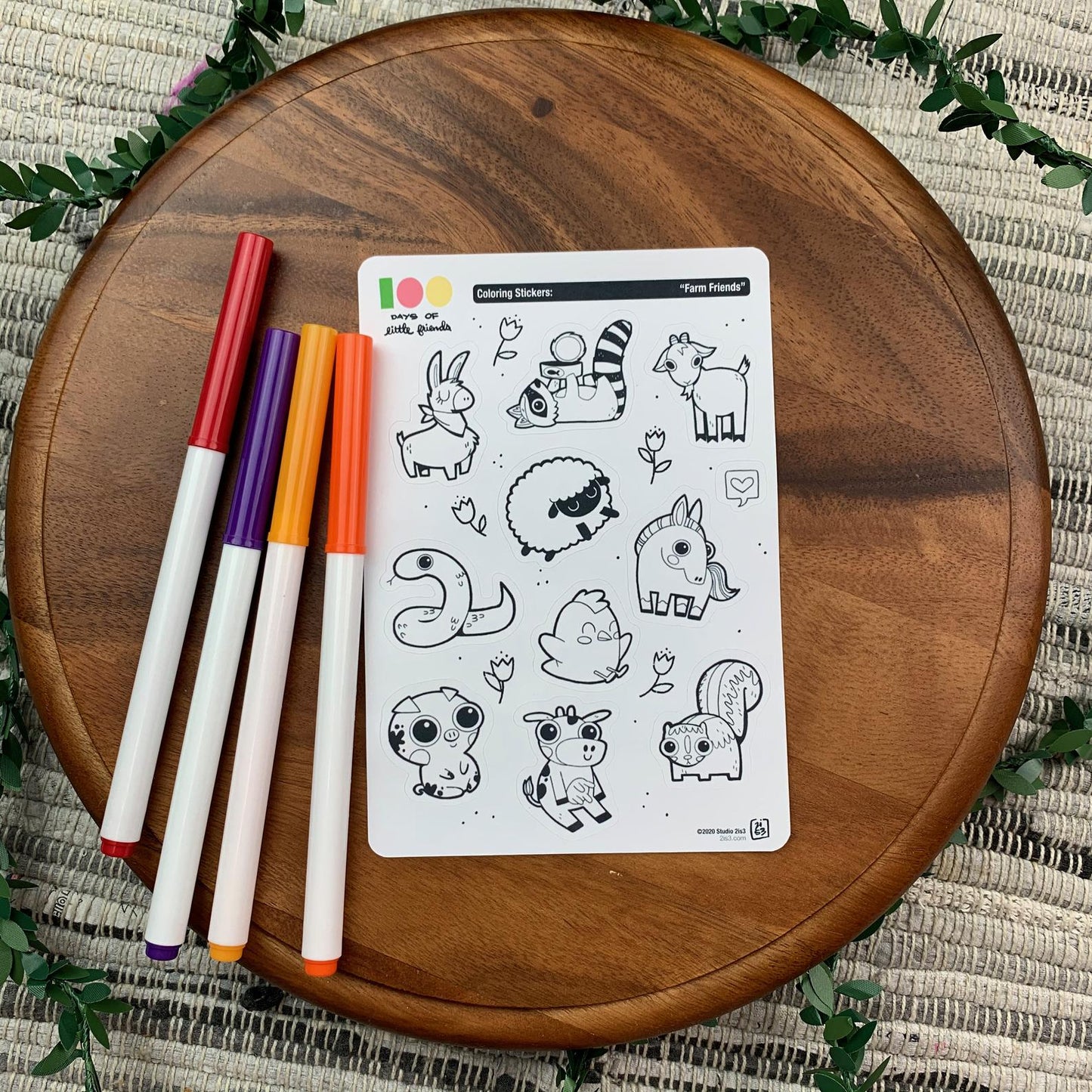 Markers and a sticker sheet with 10 little animal stickers on it. A Llama, Raccoon, Goat, Sheep, Snake, Chicken, Horse, Pig, Cow, and Skunk.