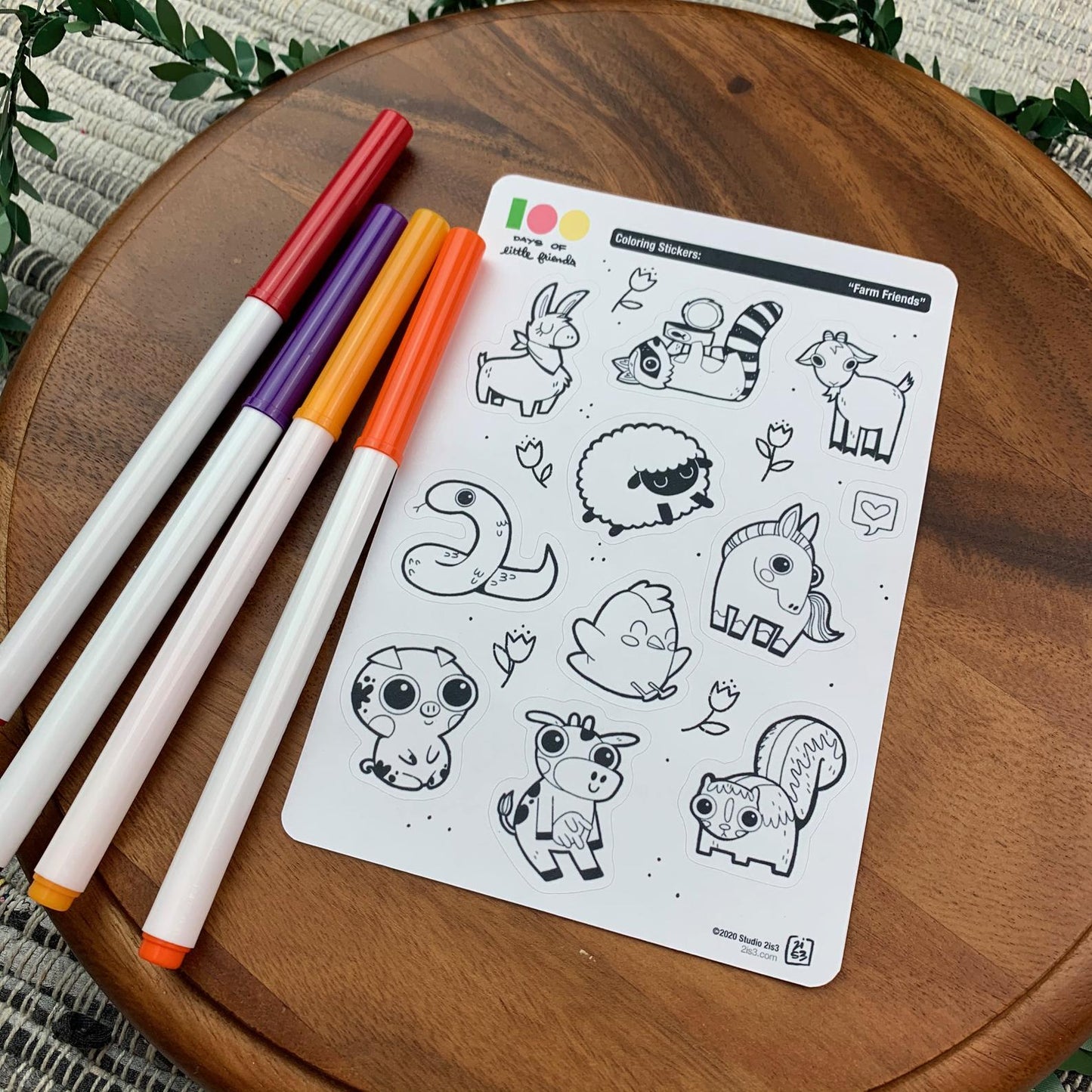 Markers and a sticker sheet with 10 little animal stickers on it. A Llama, Raccoon, Goat, Sheep, Snake, Chicken, Horse, Pig, Cow, and Skunk.