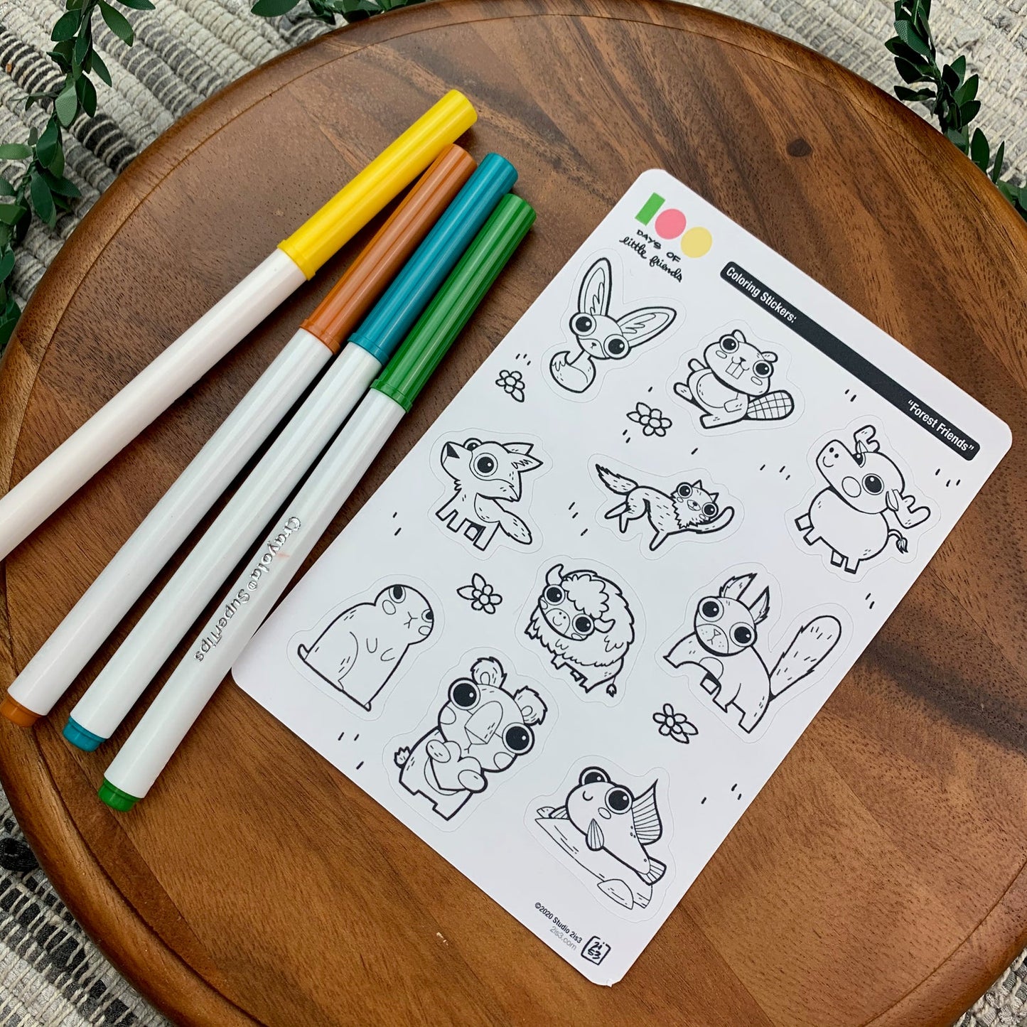 Markers and a sticker sheet with 10 little animal stickers on it. A Fox, Beaver, Moose, Wolf, Coyote, Bison, Squirrel, Prairie Dog, Bear, and Mudskipper.