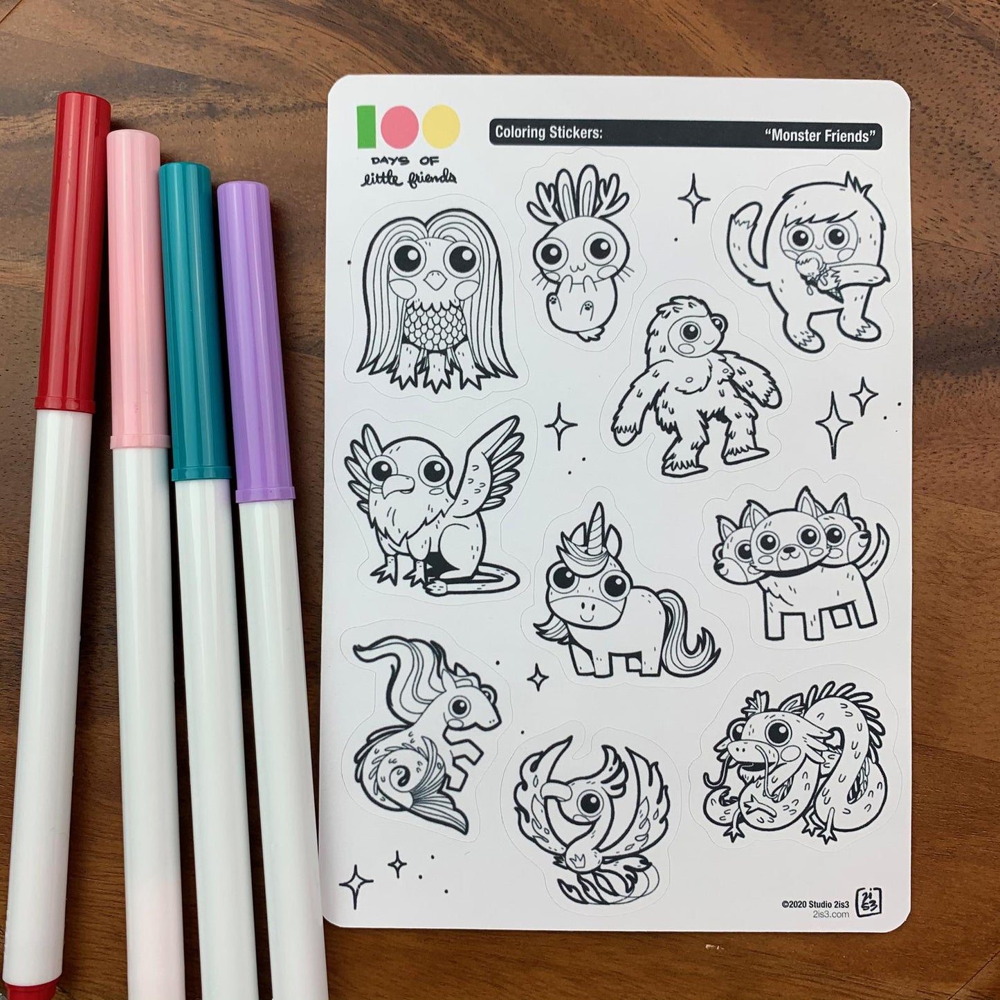 Markers and a sticker sheet with 10 little animal stickers on it. A Jackalope, Hellhound, Griffin, Phoenix, Hippocampus, Dragon, Unicorn, Bigfoot/Sasquatch, Yeti/Abominable Snowman, and Amabie.