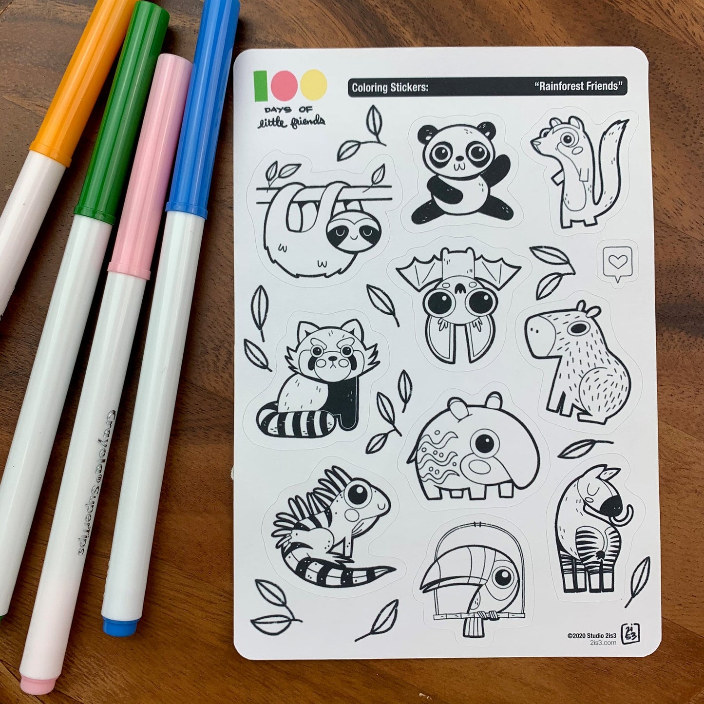 Markers and a sticker sheet with 10 little animal stickers on it. A Panda, Sloth, Mongoose, Bat, Red Panda, Capybara, Tapir, Iguana, Toucan, and Okapi.