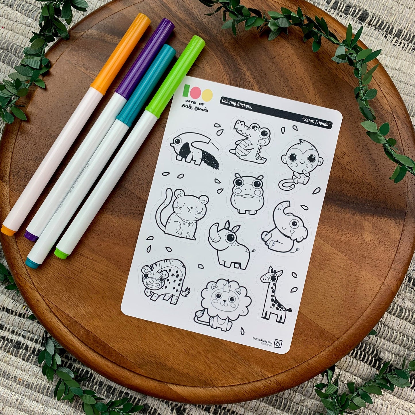 Markers and a sticker sheet with 10 little animal stickers on it. A Anteater, Alligator, Monkey, Hippo, Panther, Rhino, Elephant, Hyena, Lion, and Giraffe.