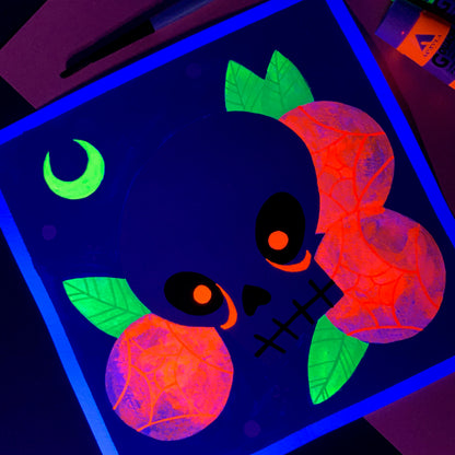 Gouache painting of a skull with glowing red eyes in blacklight.