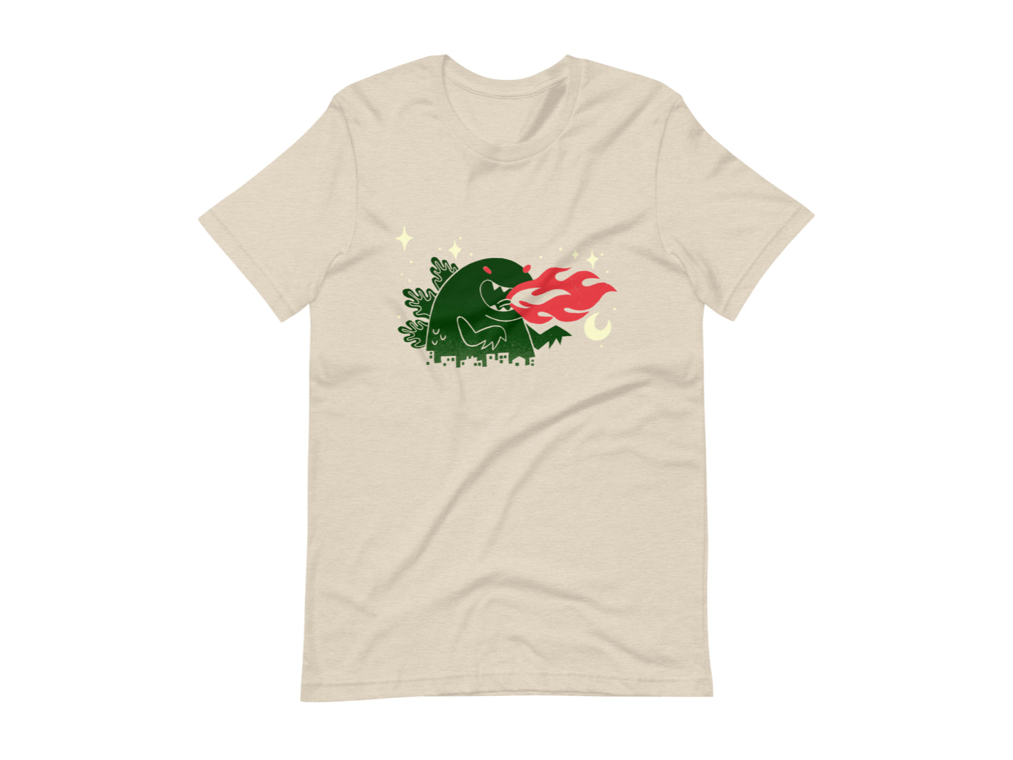 T-shirt with block print style art by Amber Orenstein. Beige shirt with a green godzilla, yellow stars, and red flames coming from his mouth.