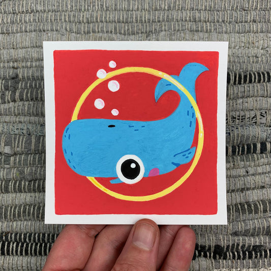 Original artwork of a cute blue whale swimming through a golden ring. Materials used: Uni-Posca paint markers.