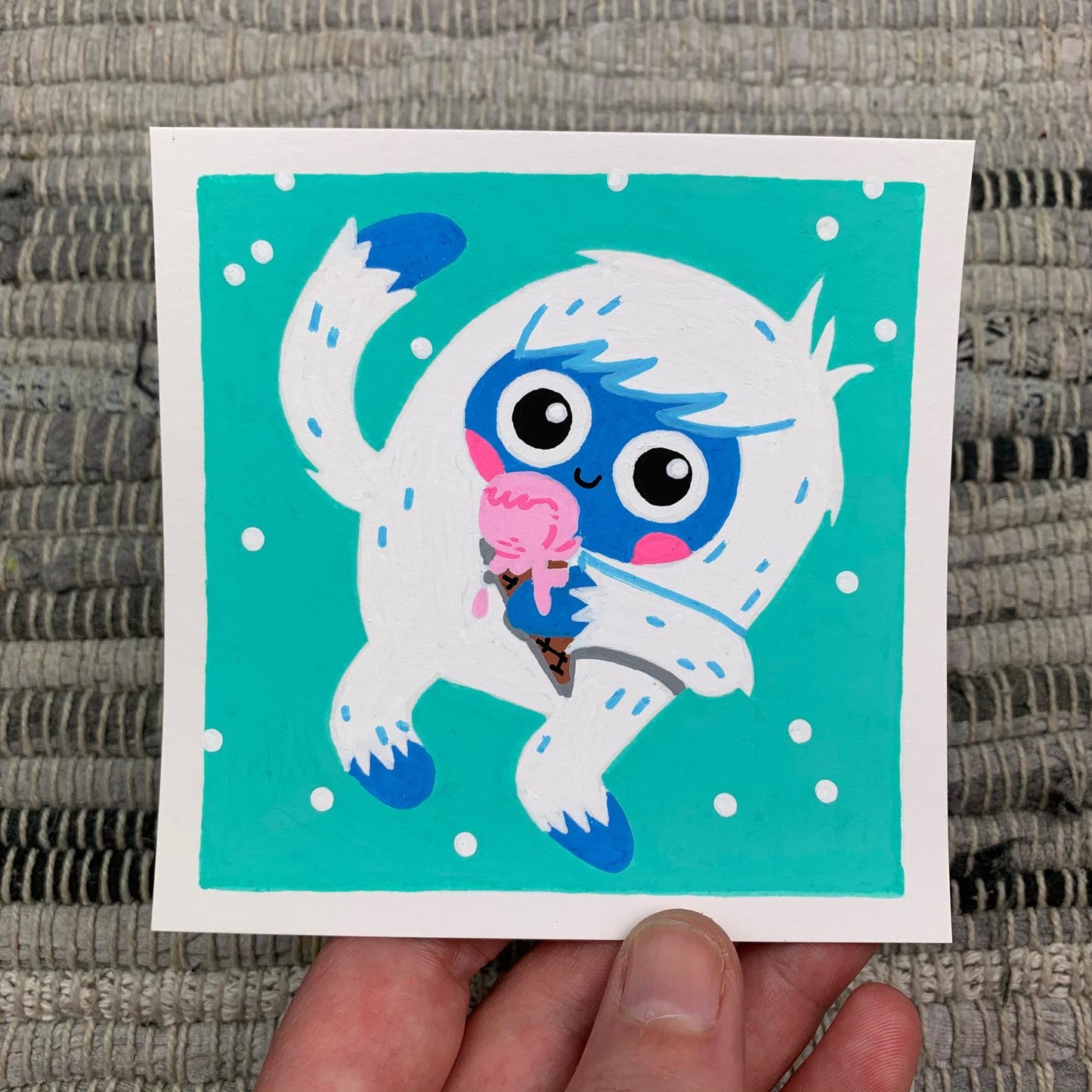 Original artwork of a cute mythical yeti (or abominable snowman) licking a pink ice cream cone in the snow. Materials used: Uni-Posca paint markers.